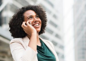 A young woman on a phone suggesting she is reporting harassment.